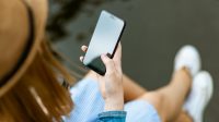 person holding smartphone white sitting