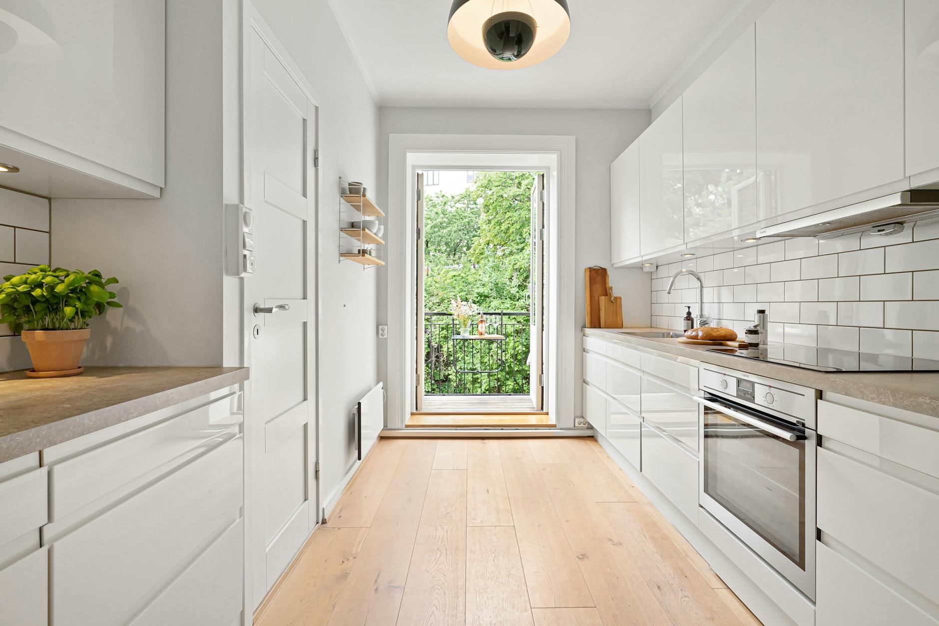 modern white minimalistic kitchen with a balcony